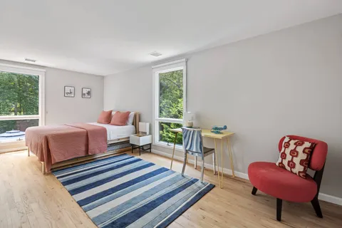 a bedroom with bed and a couch