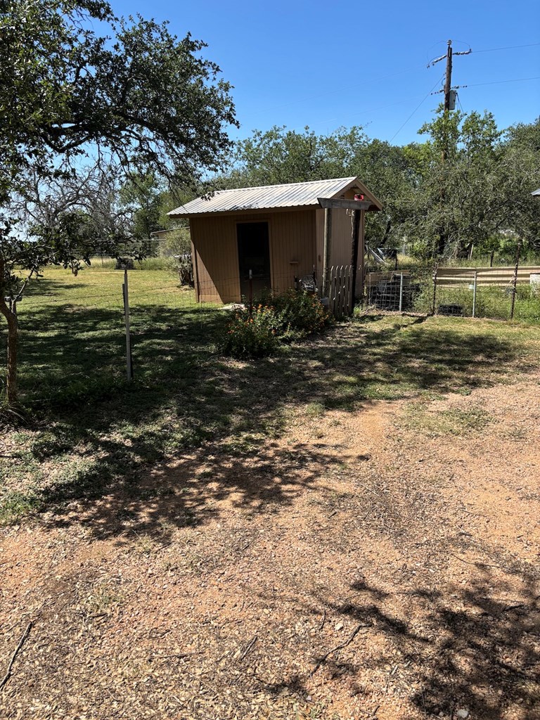 727 Cemetery Road Stonewall, TX 78671 - Photo 14 of 16 a front view of a house with a yard