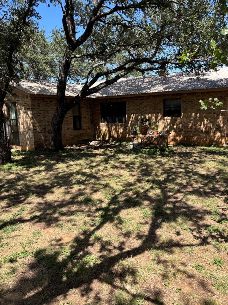 727 Cemetery Road Stonewall, TX 78671 - Photo 2 of 16 a view of a tree in front of a house