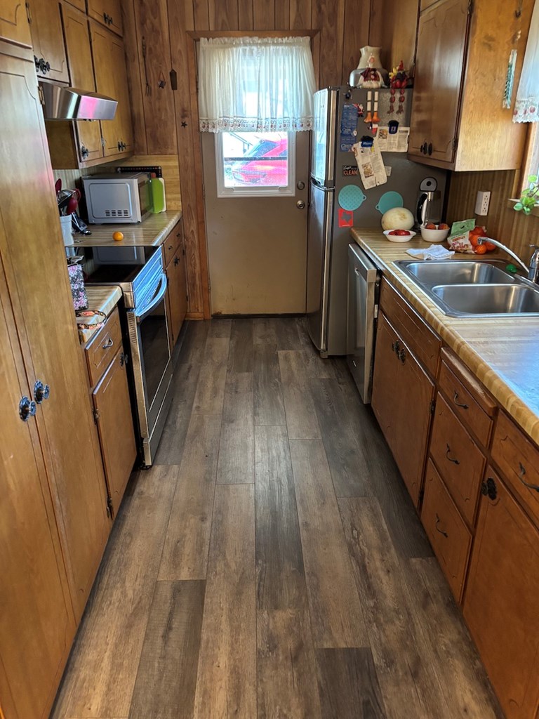 727 Cemetery Road Stonewall, TX 78671 - Photo 6 of 16 a kitchen with wooden floors and a sink
