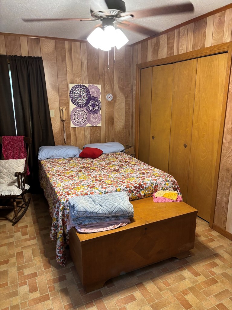 727 Cemetery Road Stonewall, TX 78671 - Photo 9 of 16 a bed sitting in a bedroom next to a window