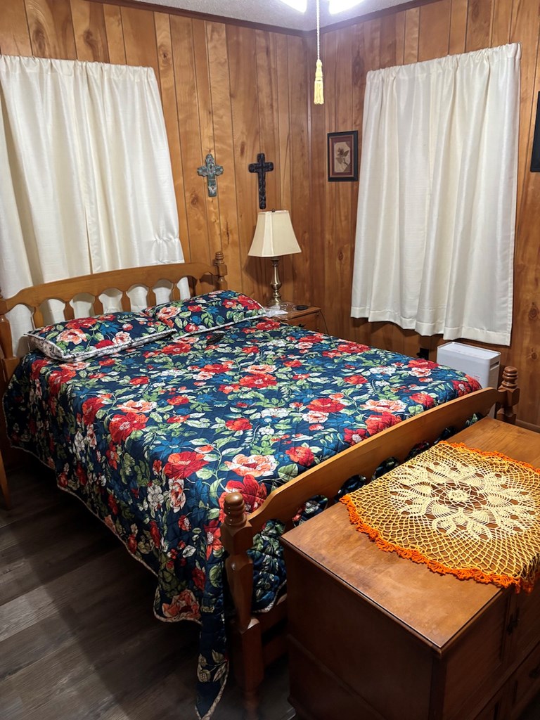 727 Cemetery Road Stonewall, TX 78671 - Photo 10 of 16 a bed sitting in a bedroom next to a window