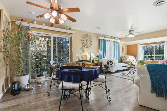 a living room with furniture a chandelier and a large window