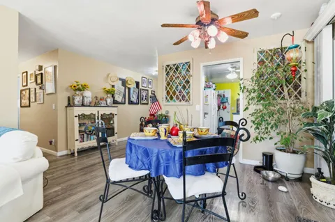 a view of a dining room with furniture and wooden floor