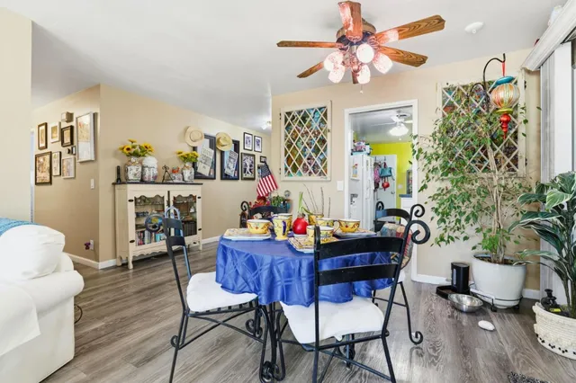 a view of a dining room with furniture and wooden floor