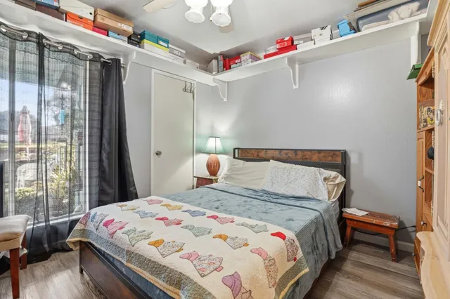 a bedroom with a bed and a potted plant