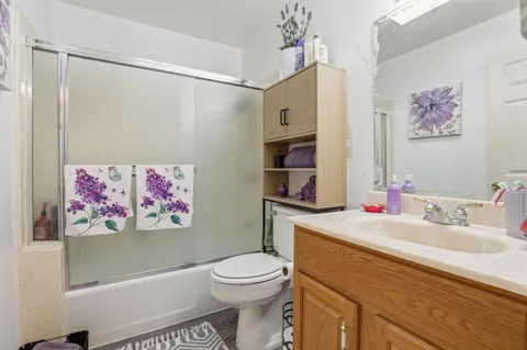 a bathroom with a sink mirror vanity and toilet