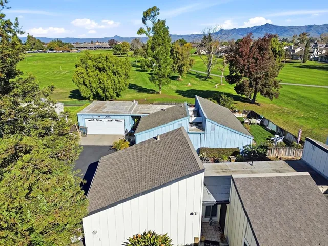 an aerial view of a house with a yard