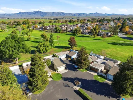 an aerial view of a houses with a garden