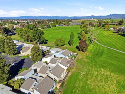 an aerial view of a houses with a yard