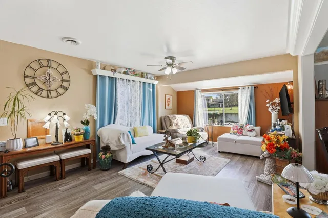 a living room with furniture and wooden floor