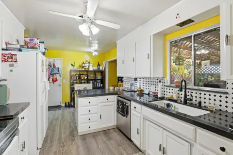 a kitchen with a sink stove and cabinets