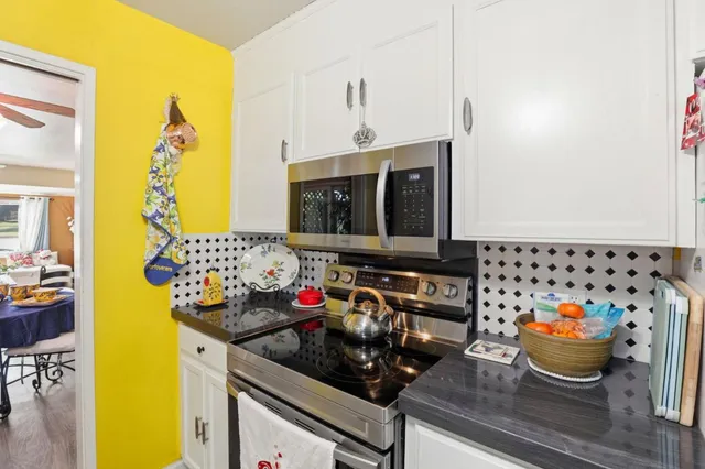 a kitchen with a sink and a stove top oven