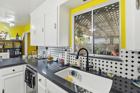 a kitchen with a sink a stove and a window