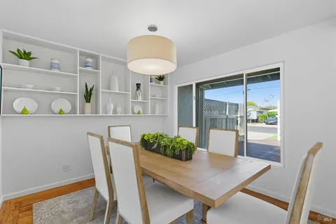 a view of a dining room with furniture and a potted plant