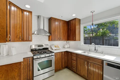 a kitchen with a sink stove and cabinets