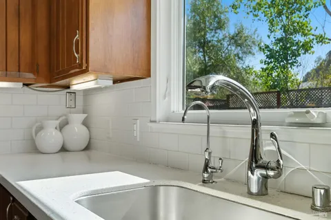 a kitchen with a sink and a wooden floor
