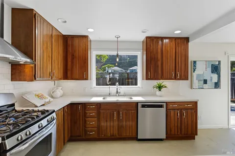 a kitchen with a sink and a stove