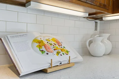a dining room with furniture a window and a kitchen view