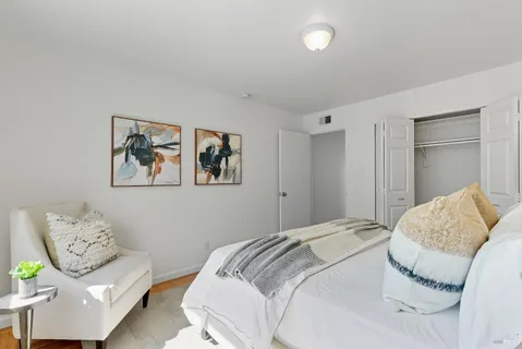 a kitchen with stainless steel appliances white cabinets and wooden floor