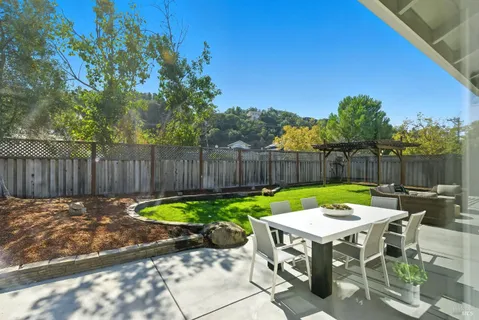 a view of backyard with outdoor seating and green space