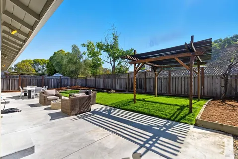 a view of a house with backyard and porch