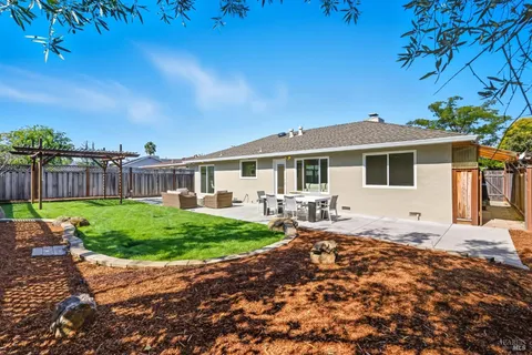 a view of a backyard with sitting area