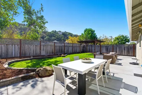 a front view of a house with patio and a garden