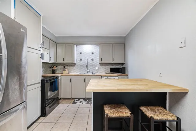 a kitchen with a sink cabinets and stainless steel appliances