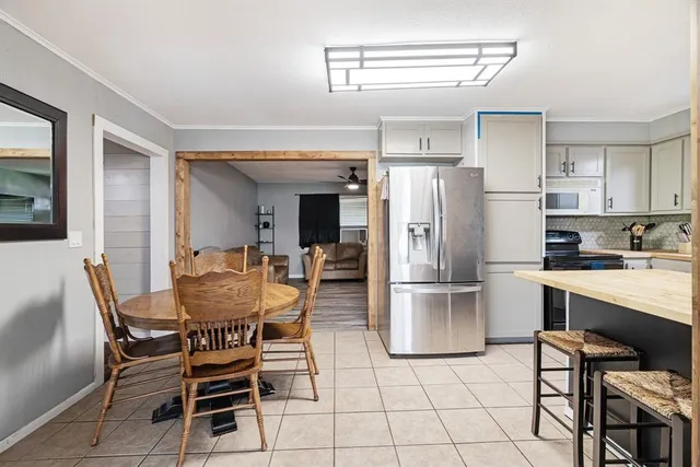 a kitchen with stainless steel appliances a refrigerator and a stove top oven
