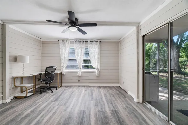 a view of a workspace with furniture window and wooden floor