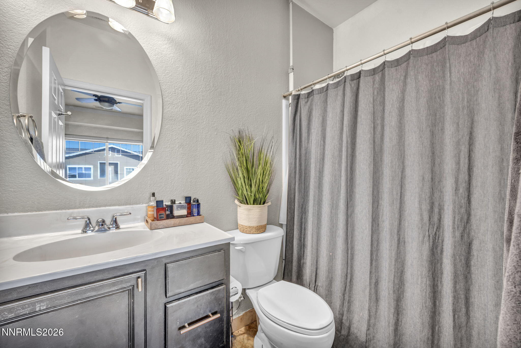 4592 Kathleen Denise Lane Reno, NV 89503 - Photo 15 of 22 a bathroom with a toilet a sink and a mirror