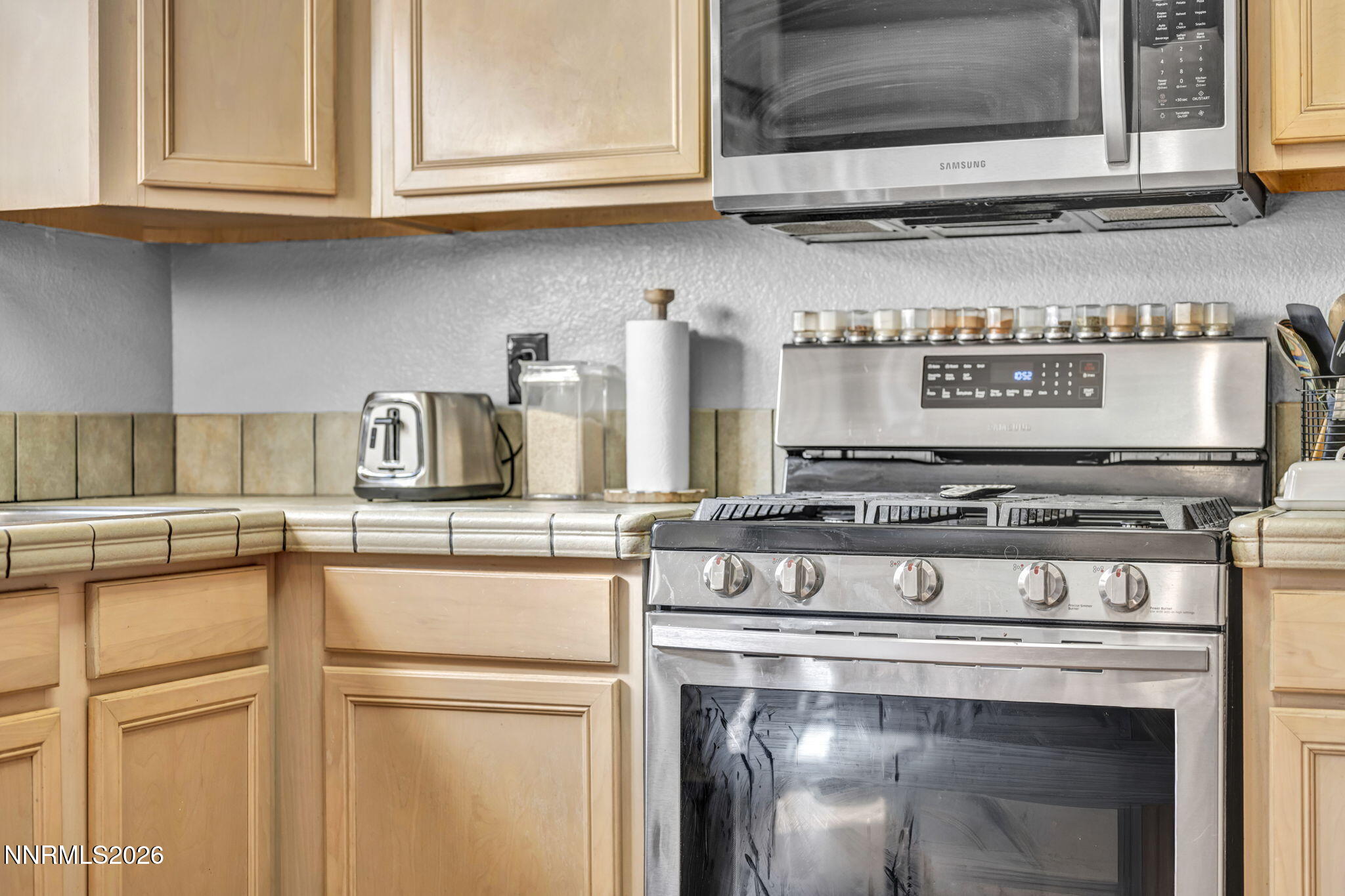 4592 Kathleen Denise Lane Reno, NV 89503 - Photo 21 of 22 a stove top oven sitting inside of a kitchen and granite counter tops
