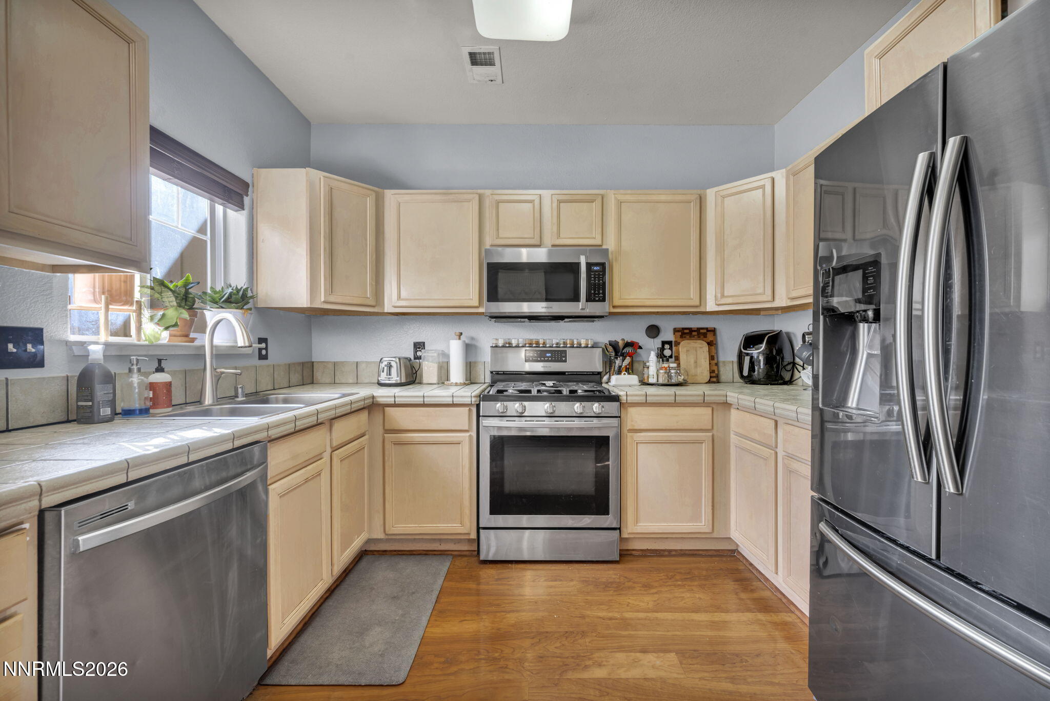 4592 Kathleen Denise Lane Reno, NV 89503 - Photo 6 of 22 a kitchen with cabinets stainless steel appliances and a window