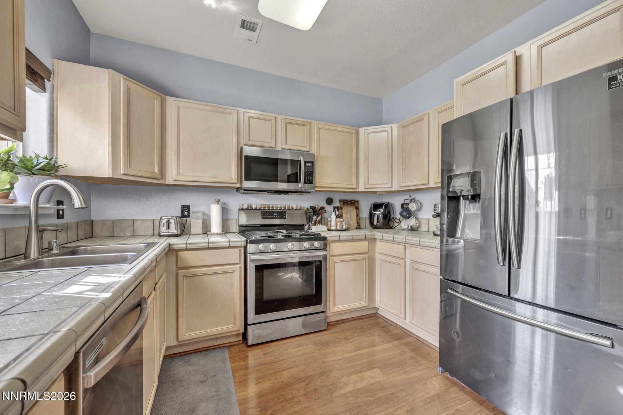 4592 Kathleen Denise Lane Reno, NV 89503 - Photo 8 of 22 a kitchen with cabinets stainless steel appliances and a sink