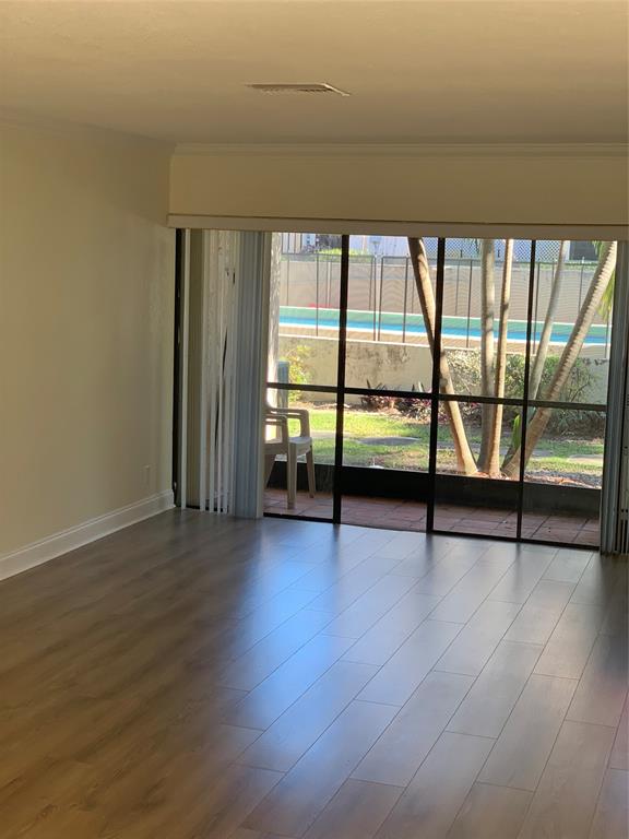 1700 Northwest 4th Avenue Boca Raton, FL 33432 - Photo 5 of 14 an empty room with wooden floor and windows