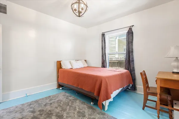 a bedroom with a bed and a desk