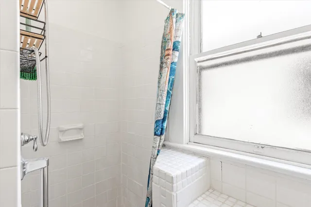 a bathroom with a tub and shower