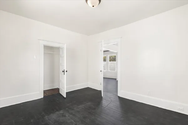 a view of an empty room with wooden floor