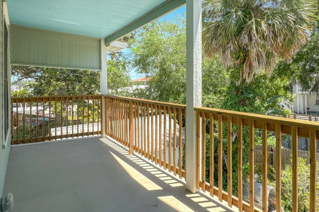 a view of a balcony with wooden floor