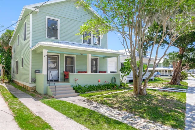 an aerial view of residential houses with outdoor space and street view