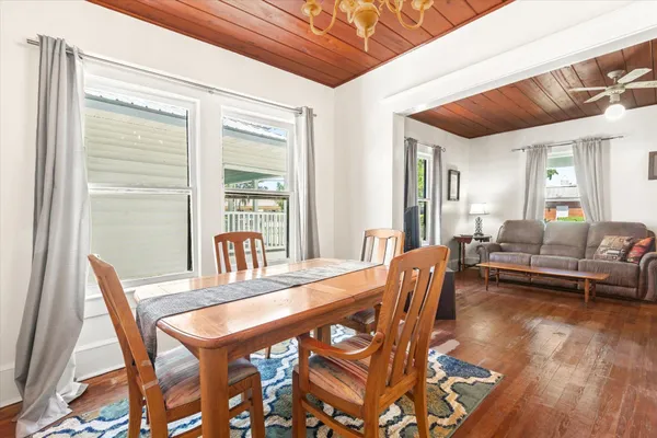 a view of a dining room with furniture wooden floor and a rug