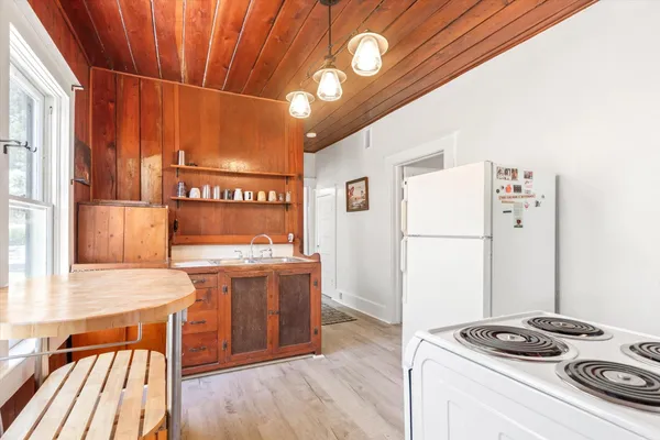 a kitchen with a refrigerator and a stove