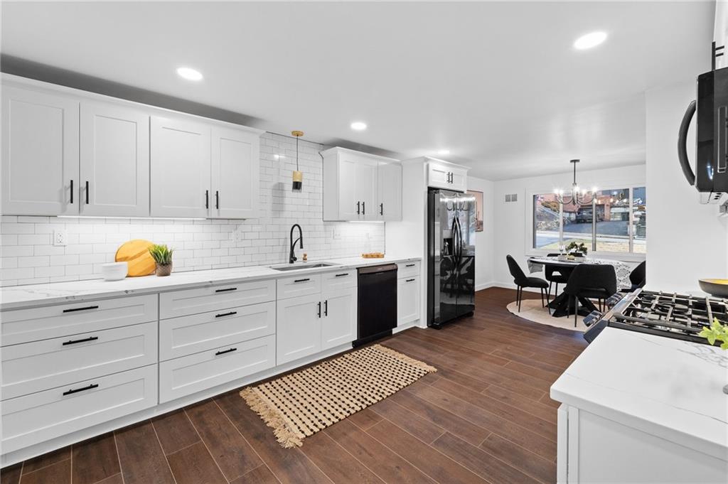 566 Kelso Road Pittsburgh, PA 15243 - Photo 13 of 40 a view of kitchen with cabinets stainless steel appliances and wooden floor