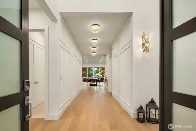 a hallway with furniture and floor to ceiling window