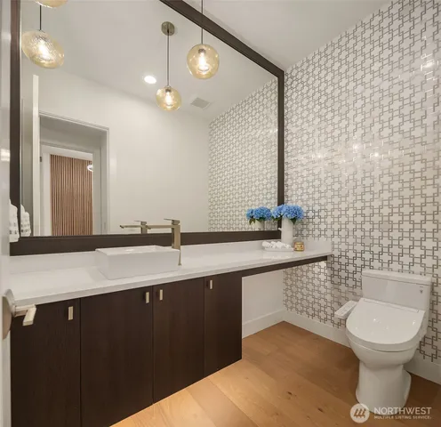 a bathroom with a sink a toilet and a mirror