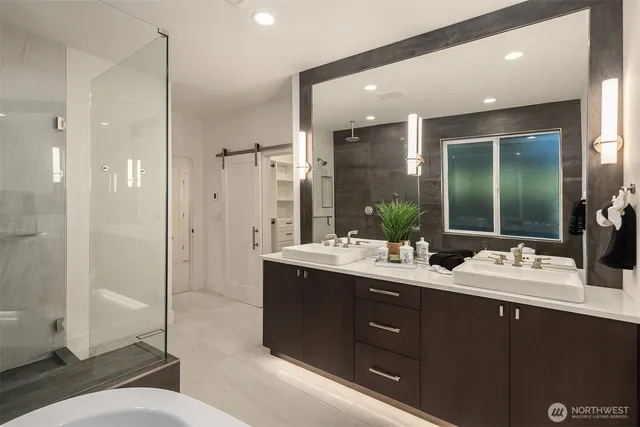 a bathroom with a double vanity sink toilet mirror and shower