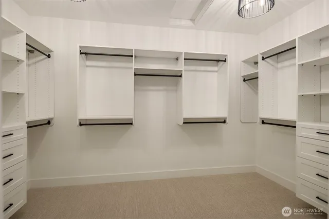 a view of walk in closet with empty racks
