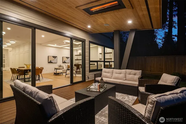 a living room with furniture and a floor to ceiling window