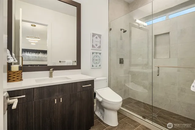 a bathroom with a sink toilet and shower